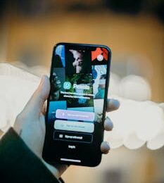 A person holding a smartphone displaying the Pexels app, highlighting the login screen.