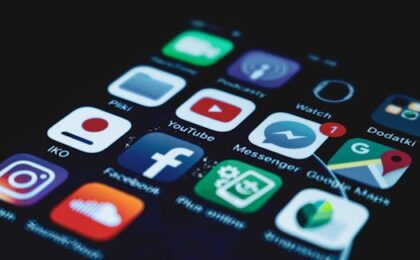 Detailed close-up view of a smartphone screen displaying various popular social media app icons.